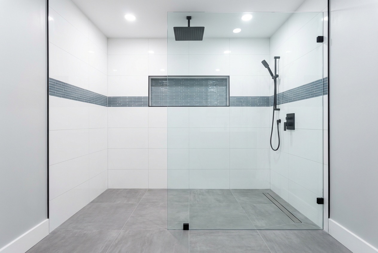 Curbless walk-in shower with frameless glass and rainfall head